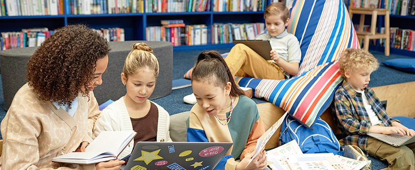 kilby kids learning with a teacher at a table