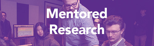 man helping students on audio board